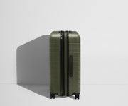 Side product view of The Medium Flex suitcase in Sea Green shown fully expanded