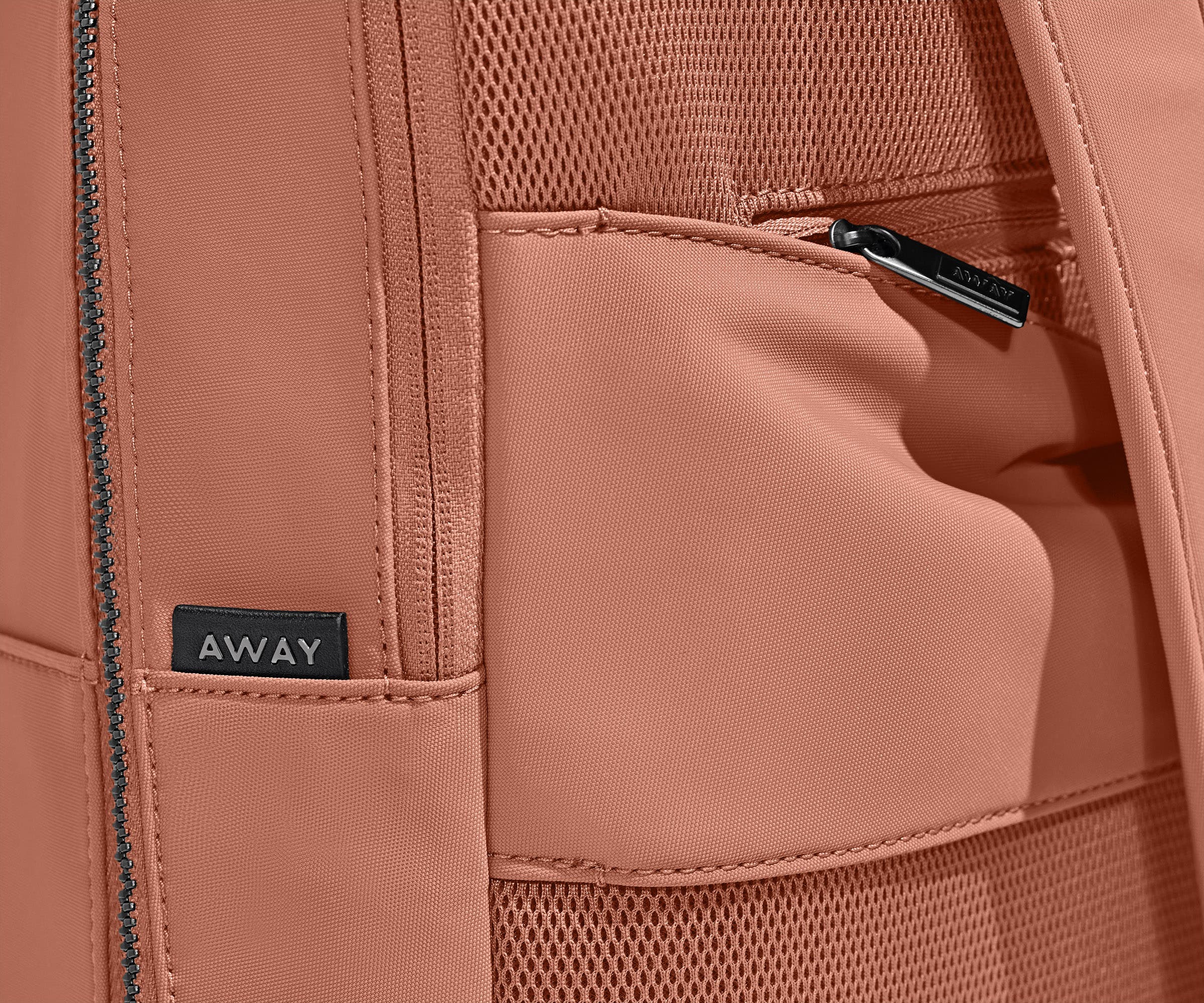 Close up view of the trolley sleeve and hidden zip pocket on the back of the backpack