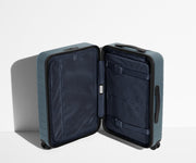 The Bigger Carry-On suitcase in Coast Blue shown open in an upright position to show interior organization and compression system