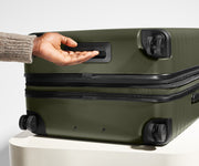 The Medium Flex suitcase in Sea Green shown from below highlighting the underside grab handle