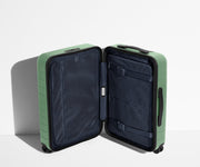 The Bigger Carry-On suitcase in Sea Green shown open in an upright position to show interior organization and compression system