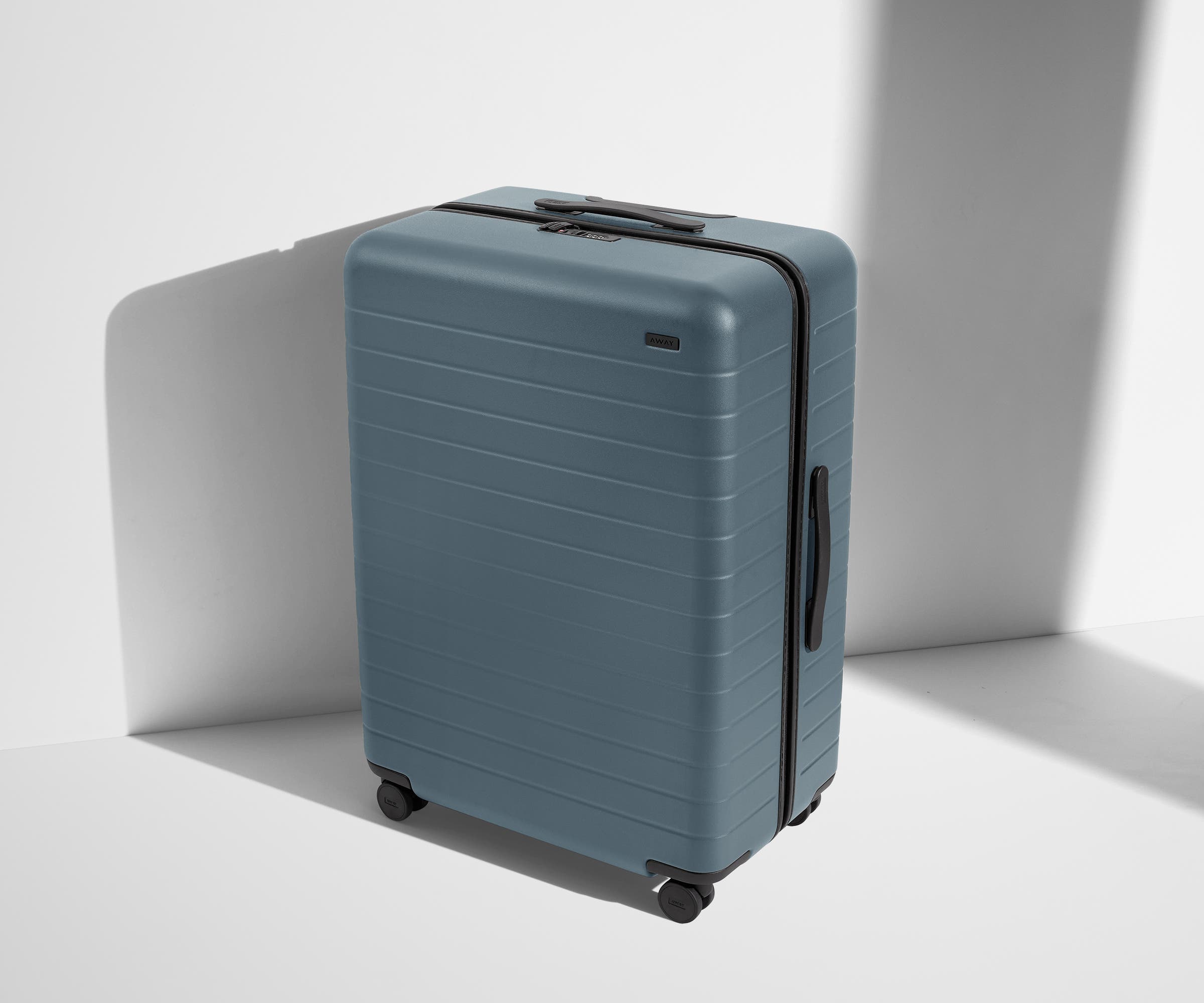 Angled product view of The Large suitcase in Coast Blue