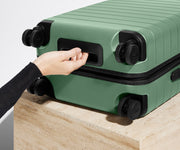 The Bigger Carry-On suitcase in Sea Green shown from below highlighting the underside grab handle