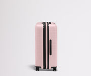 Side product view of The Medium Flex suitcase in Blush Pink shown fully expanded