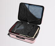 The Medium Flex suitcase in Blush Pink shown open on its side and packed with Away's packing organizers to show capacity and the interior compression system, designed to help you pack more in