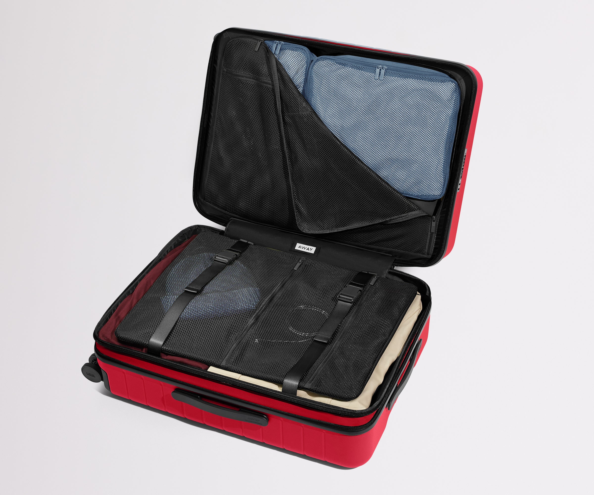 Red suitcase with open lid showing black interior