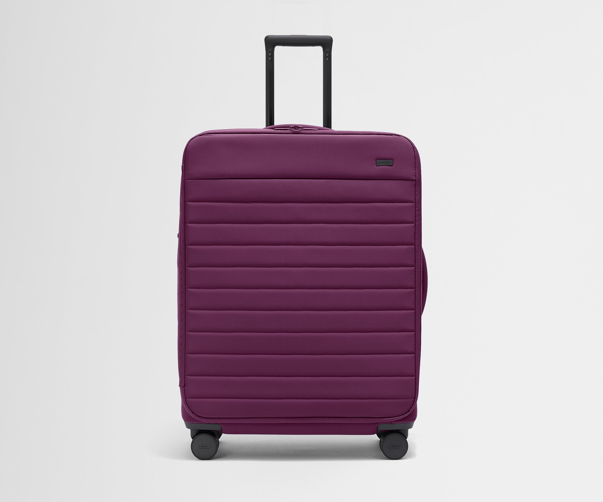 Front product view of The Softside Large suitcase in Plum Purple with raised handle